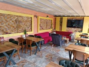 a restaurant with tables and chairs and a couch at Grand Bona Sera Hotel in Istanbul