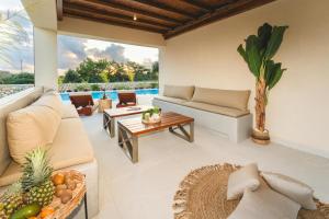 a living room with a couch and a table at Cleopatra's Villa Luxury Retreat South Rhodes in Lachania