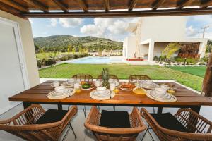 a wooden table with food on it on a patio at Aiolia Villa in Lachania