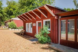 eine rote Kabine mit einem großen Fenster im Hof in der Unterkunft Heimathafen in Ückeritz