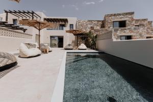 an infinity pool in the backyard of a house at ONYM Curated Villas in Plaka