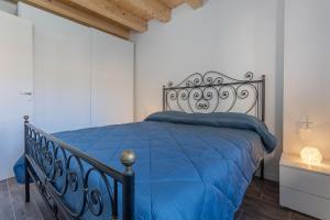 a bedroom with a bed with a blue comforter at Casa Gemma Comfortable Apartment in Bologna