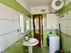 a small bathroom with a sink and a toilet at Guest House Dimos Kristi in Përmet