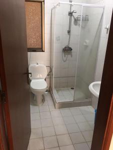 a bathroom with a shower and a toilet and a sink at Luxery Apartment in Tuzla