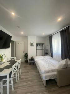 a bedroom with a large bed and a dining table at Secret Collection Thermenresort in Frauenkirchen