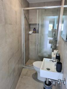 a bathroom with a shower and a toilet and a sink at Casa Limo in São Martinho do Porto