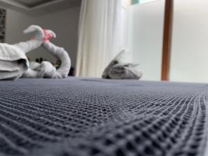 a close up of a bed with a comforter at Gardenya Lara Suit Hotel in Antalya