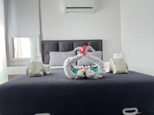 a bedroom with a bed with a knitted at Gardenya Lara Suit Hotel in Antalya