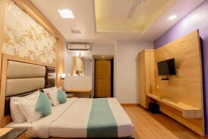 a hotel room with a bed and a tv at FabHotel Prime Aroma Residency in Jaipur