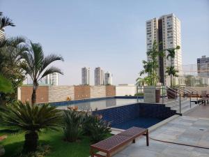 a swimming pool in a city with tall buildings at Pulse - Easy Life - Vaca Brava in Goiânia