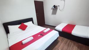 Postel nebo postele na pokoji v ubytování Hotel Rasa Sayang 2