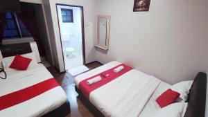 Postel nebo postele na pokoji v ubytování Hotel Rasa Sayang 2