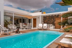 a swimming pool in the backyard of a villa at Villa Shepherd Lajares - LUXURY VILLA FUERTEVENTURA in Lajares