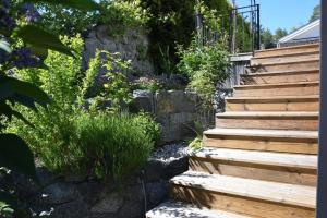 a garden with wooden stairs and plants at Ferienhaus in Håbo mit Privatem Pool in Skokloster