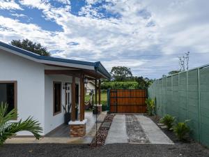 a house with a gate and a fence at House Monstera Arenal in Agua Azul