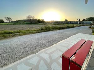a red bench sitting on the side of a road at Efi studios 2 in Kardamaina