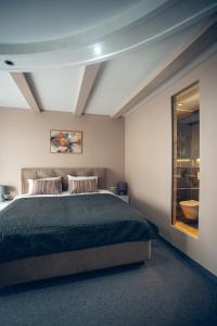 a bedroom with a large bed and a window at Apart4you Hotel in Chişinău