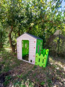 a small play house in the grass under a tree at Gite 6 personnes in Vesseaux