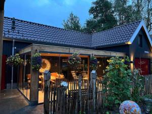 a fence in front of a building with a restaurant at B&B de Witte Weide in Nieuwlande
