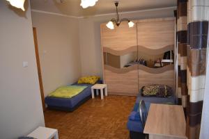 a room with two bunk beds and a table at Pokoje Jasionka Zaczernie in Trzebownisko