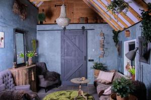 a living room with a barn door and a couch at B&B de Witte Weide in Nieuwlande