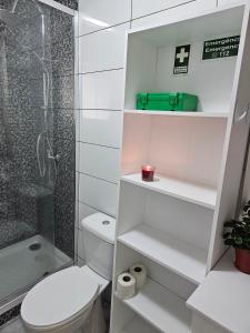 a white bathroom with a shower and a toilet at SB Alojamento in Amora