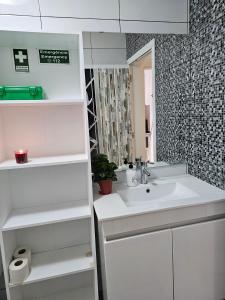 a white bathroom with a sink and a mirror at SB Alojamento in Amora