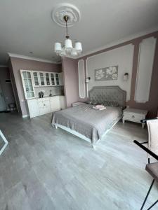 a bedroom with a bed and a chandelier at Dream apartment in Batumi