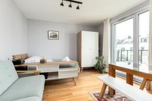 - un salon avec un bureau et un canapé dans l'établissement Marina Gdańsk Cosy Studio, à Gdańsk
