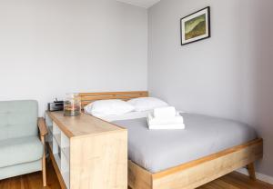 - une petite chambre avec un lit et un bureau dans l'établissement Marina Gdańsk Cosy Studio, à Gdańsk