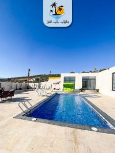 a swimming pool in front of a building at The palm heaven chalets in Jerash