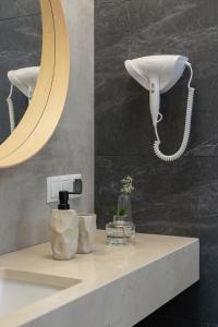 a bathroom counter with a mirror and a sink at Kazimierz District - Dietla 21 - Studio Apartment in Krakow