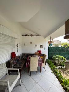 a patio with a couch and a table and chairs at Villa 19 Apart Otel in Ilıca