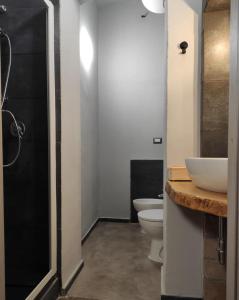 a bathroom with two toilets and a sink and a shower at ZED-HOUSE in Nizza Monferrato