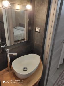 a bathroom with a sink and a mirror at ZED-HOUSE in Nizza Monferrato