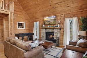 a living room with a fireplace and a piano at Updated family friendly Cabin, hot tub, near Gatlinburg, Pigeon Forge, Dollywood in Sevierville