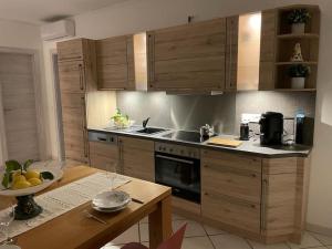 a kitchen with wooden cabinets and a wooden table at Guest House Ida in Cetara