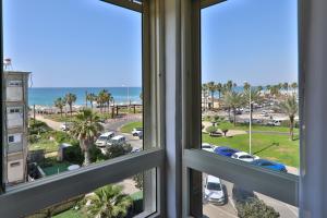 a view of the ocean from a hotel window at שקיעה בים - דירות נופש יוקרתיות עם ג'קוזי ונוף לים in Haifa