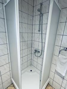 a shower with a glass door in a bathroom at Tribistovo Holiday House in Posušje
