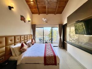 a bedroom with a large bed and a large window at Wanna Stay Bhimtal in Bhīm Tāl
