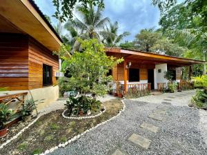 a house with a tree in front of it at Ana's Bungalow in Siquijor