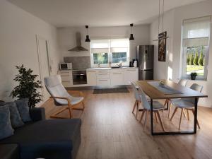 a kitchen and living room with a table and chairs at Holiday Home Mierki in Olsztynek