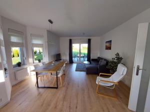 a living room with a table and a couch at Holiday Home Mierki 2 in Olsztynek