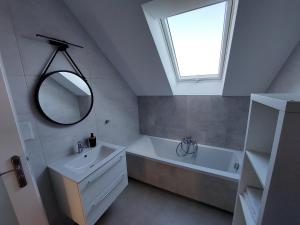 a bathroom with a sink and a tub and a mirror at Holiday Home Mierki 2 in Olsztynek