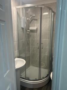 a bathroom with a glass shower and a sink at Studio Flat 7 With Private Shower & WC in Nottingham