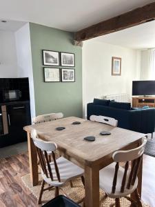 a wooden table and chairs in a living room at Cadwgan House in Rhayader