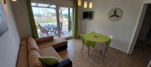 a living room with a couch and a table at Apartments Batistić in Supetarska Draga