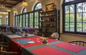 a dining room with tables and a teddy bear sitting at it at Yun Shan Shuei Castle in Fengping