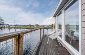 a balcony with a bench and a view of the water at Amsterdam Boathouse in Aalsmeer