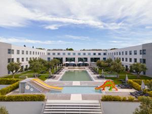 un gran edificio con piscina y tobogán en Vila Gale Evora en Évora